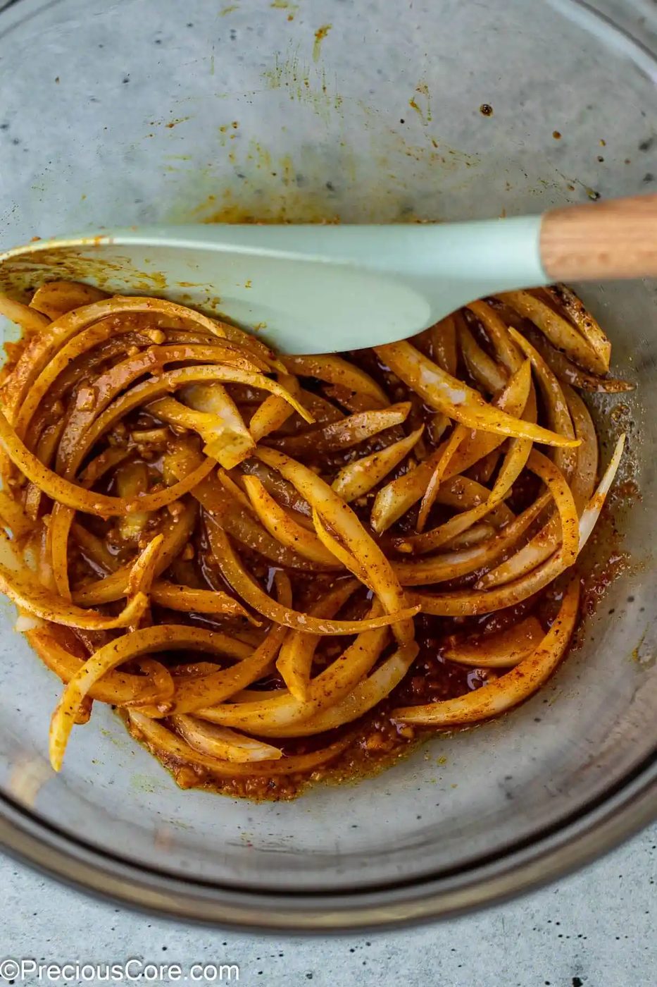 Onions and marinade ingredients in bowl.