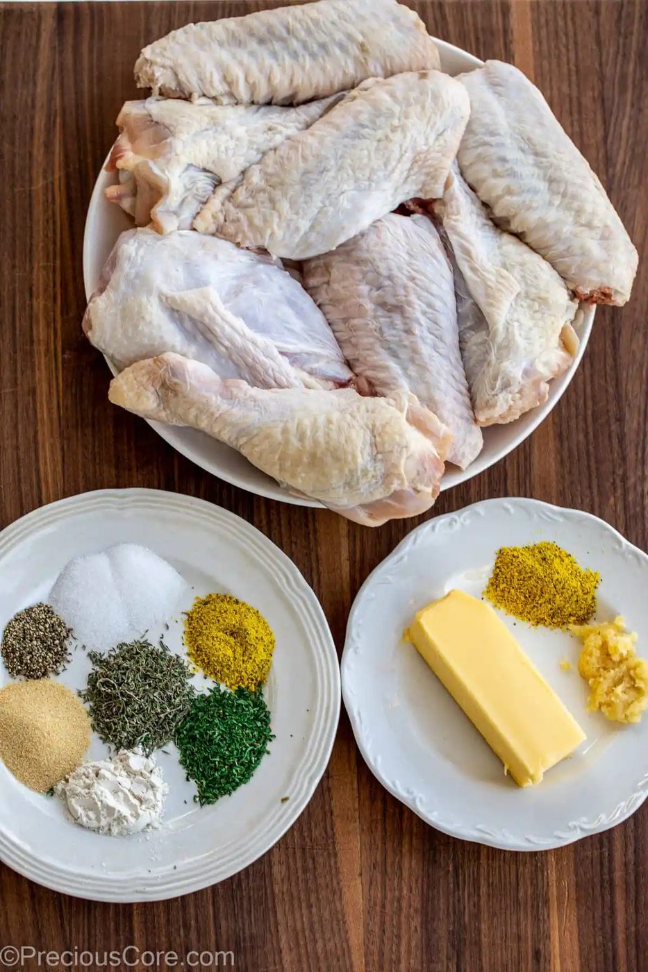 Turkey Wings, seasoning and butter on a chopping board.