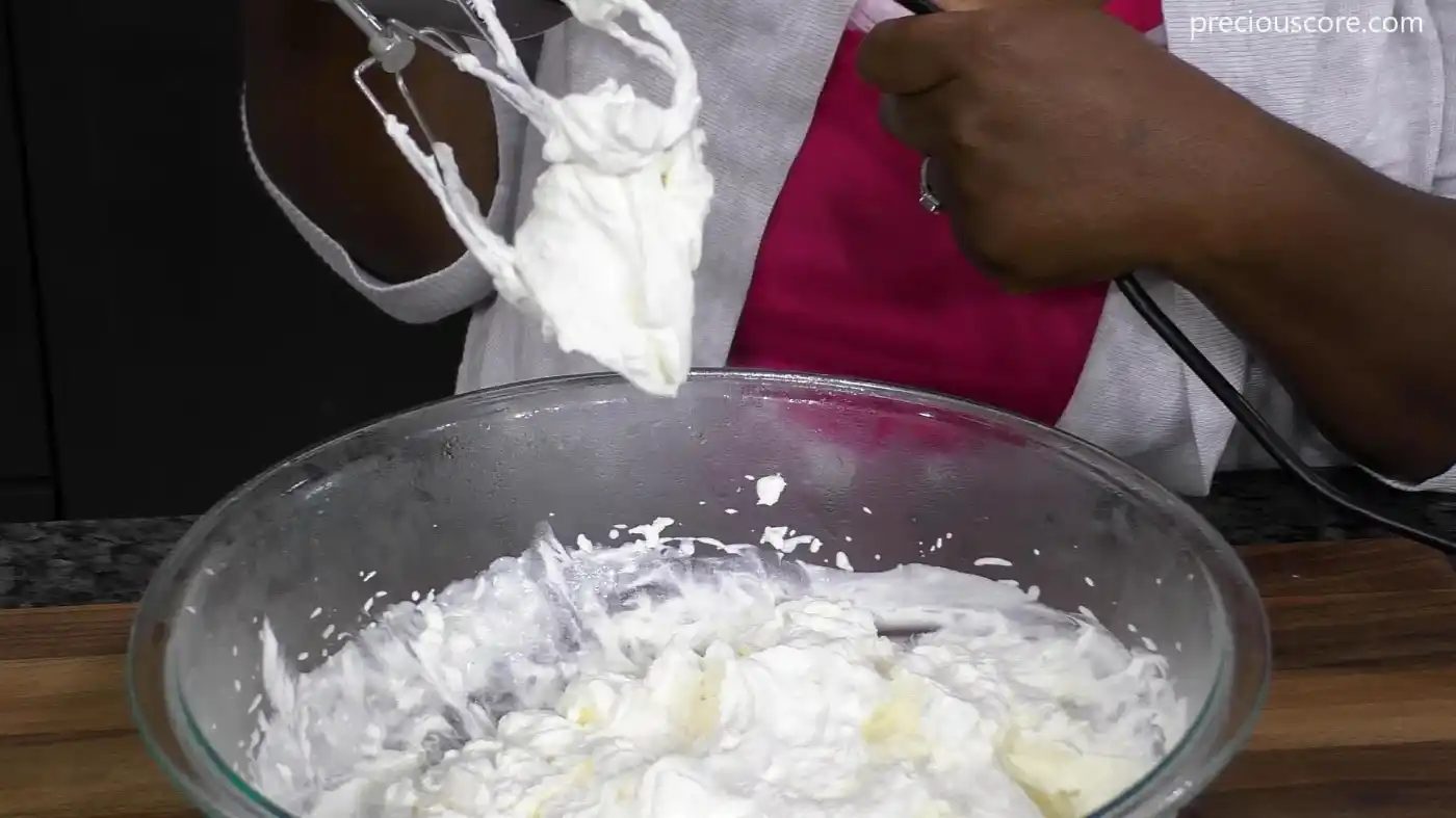 Heavy cream in a bowl beaten to stiff peaks
