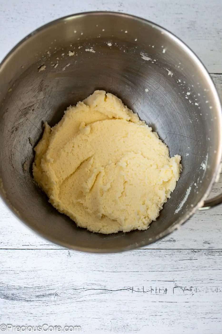 Mixed butter and sugar in a bowl.