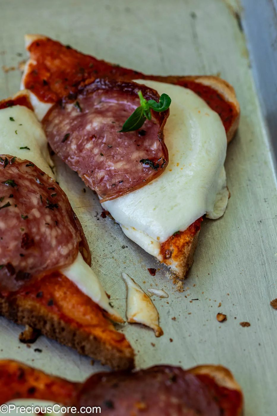 Close-up of a triangle of pizza toast.