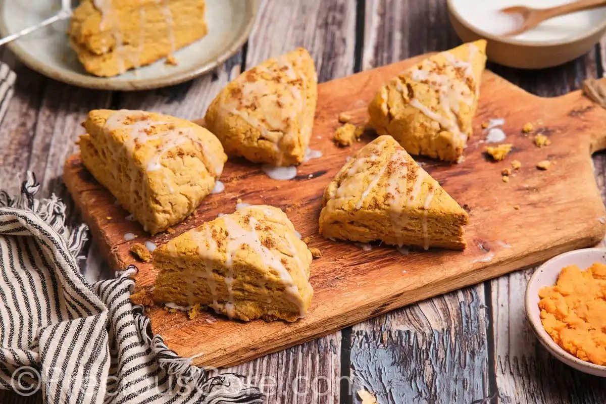 The most satisfying scones on a wooden chopping board.