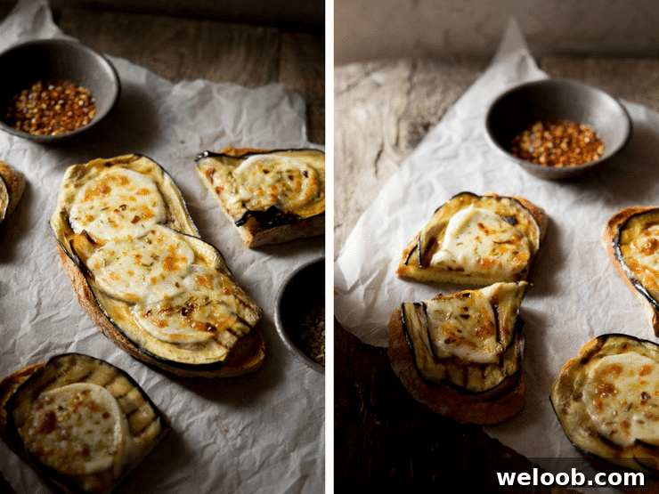 A close up of eggplant bruschetta with mozzarella sitting on crushed baking paper on a wooden surface