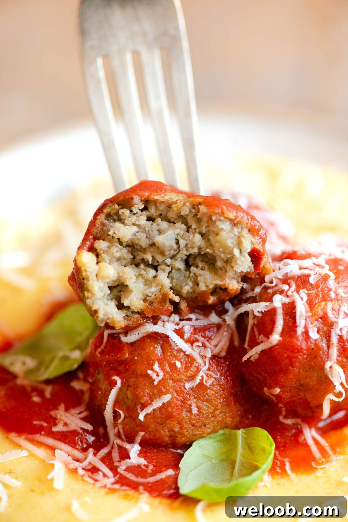 A close up of an eggplant meatball cut in half