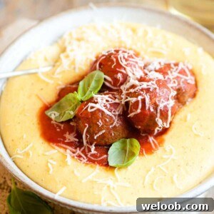 A close up of eggplant meatballs on top of polenta