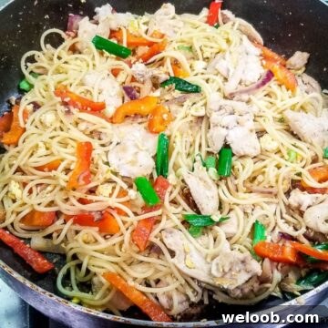 Stir fry with spaghetti and chicken in a pan
