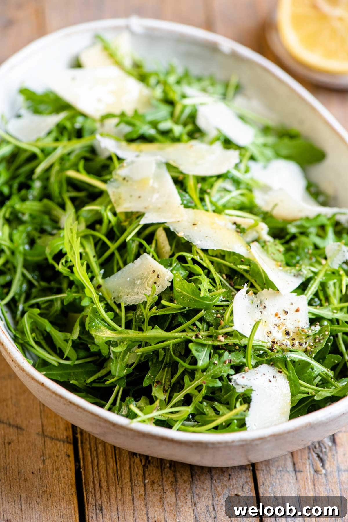 A close up of an arugula salad in a bowl