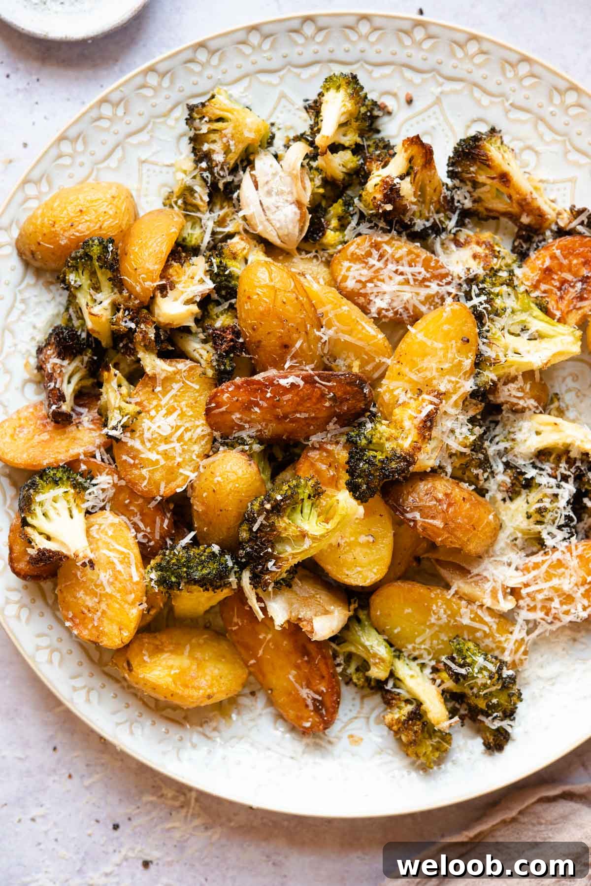 An overhead shot of roasted potatoes and broccoli on a plate