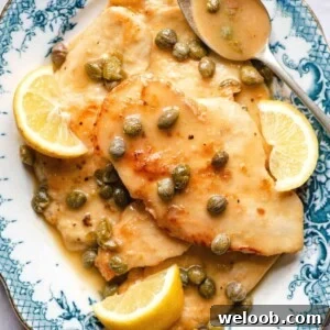A close up of chicken piccata on a blue plate