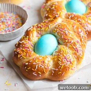 A close up of Italian Easter bread with sprinkles and a blue egg in the middle