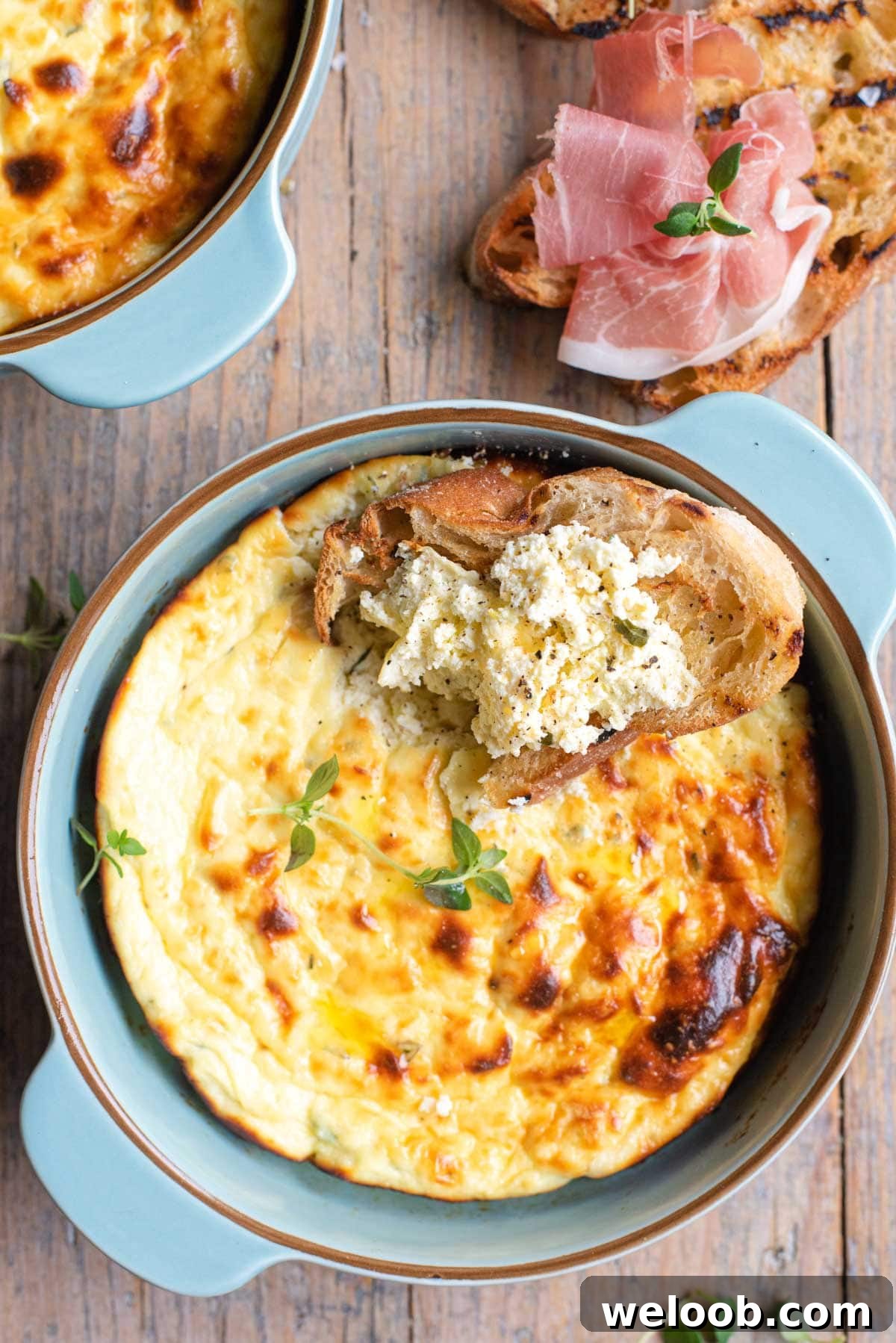 A close up of baked ricotta in a dish and on some bread