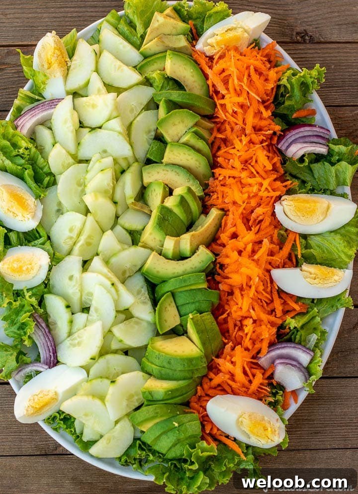 Lettuce, cucumbers and other vegetables on a platter.