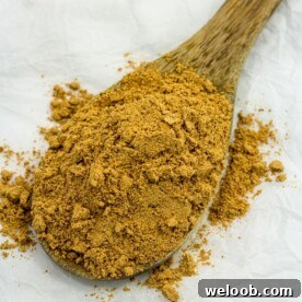 Suya spice on a wooden spoon.