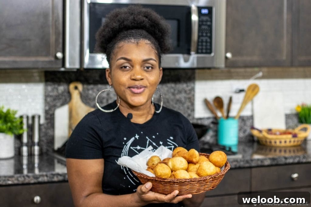 Woman holding basket of puff puff - Cameroonian Street Food
