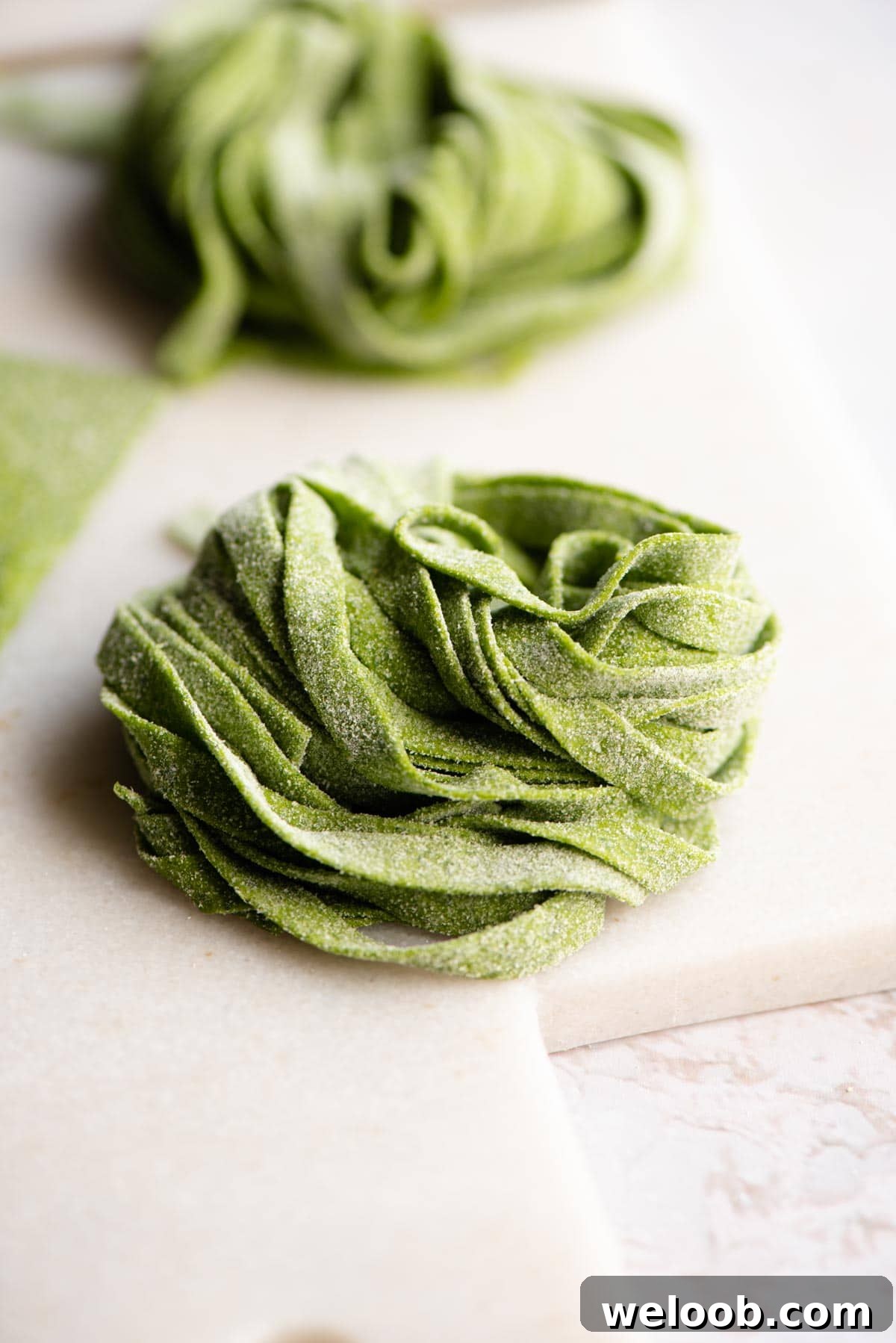 A close up of raw spinach tagliatelle