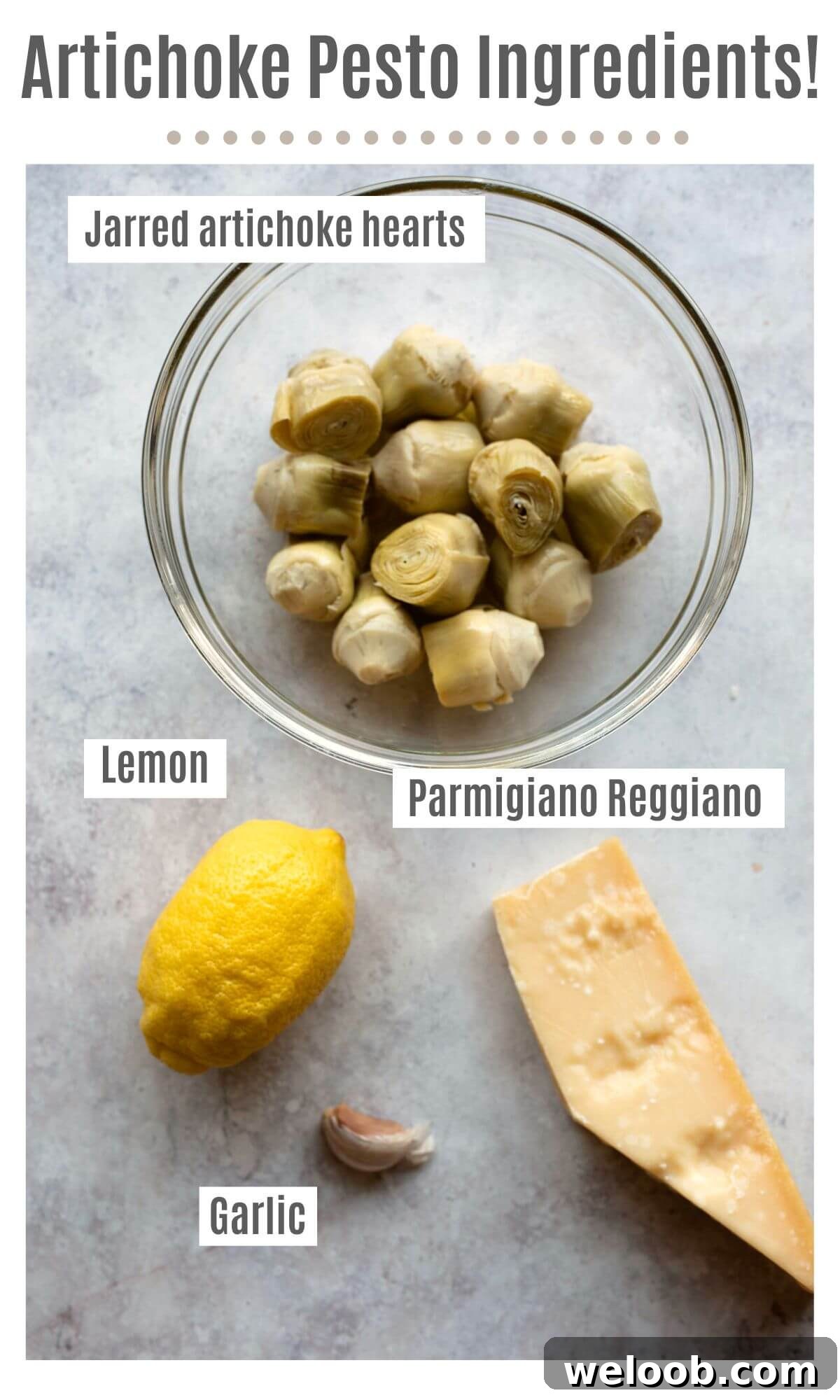 An overhead shot of labelled ingredients needed to make artichoke pesto; jarred artichoke hearts, lemon, Parmigiano Reggiano and garlic.