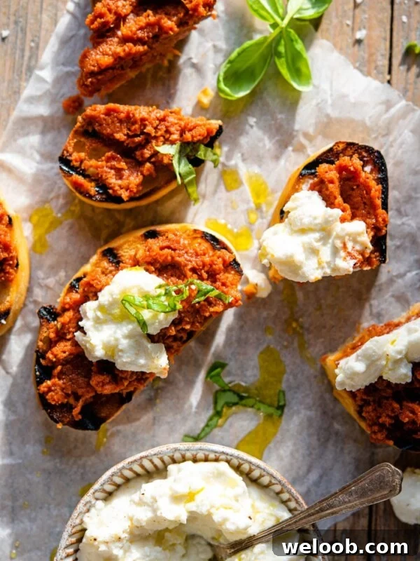 An overhead shot of red pesto on ciabatta bread with ricotta