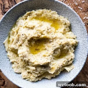 A close up square image of artichoke pesto in a bowl.