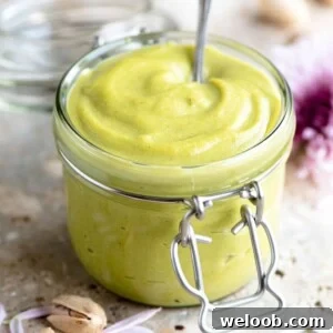 A close up of pistachio cream in a jar