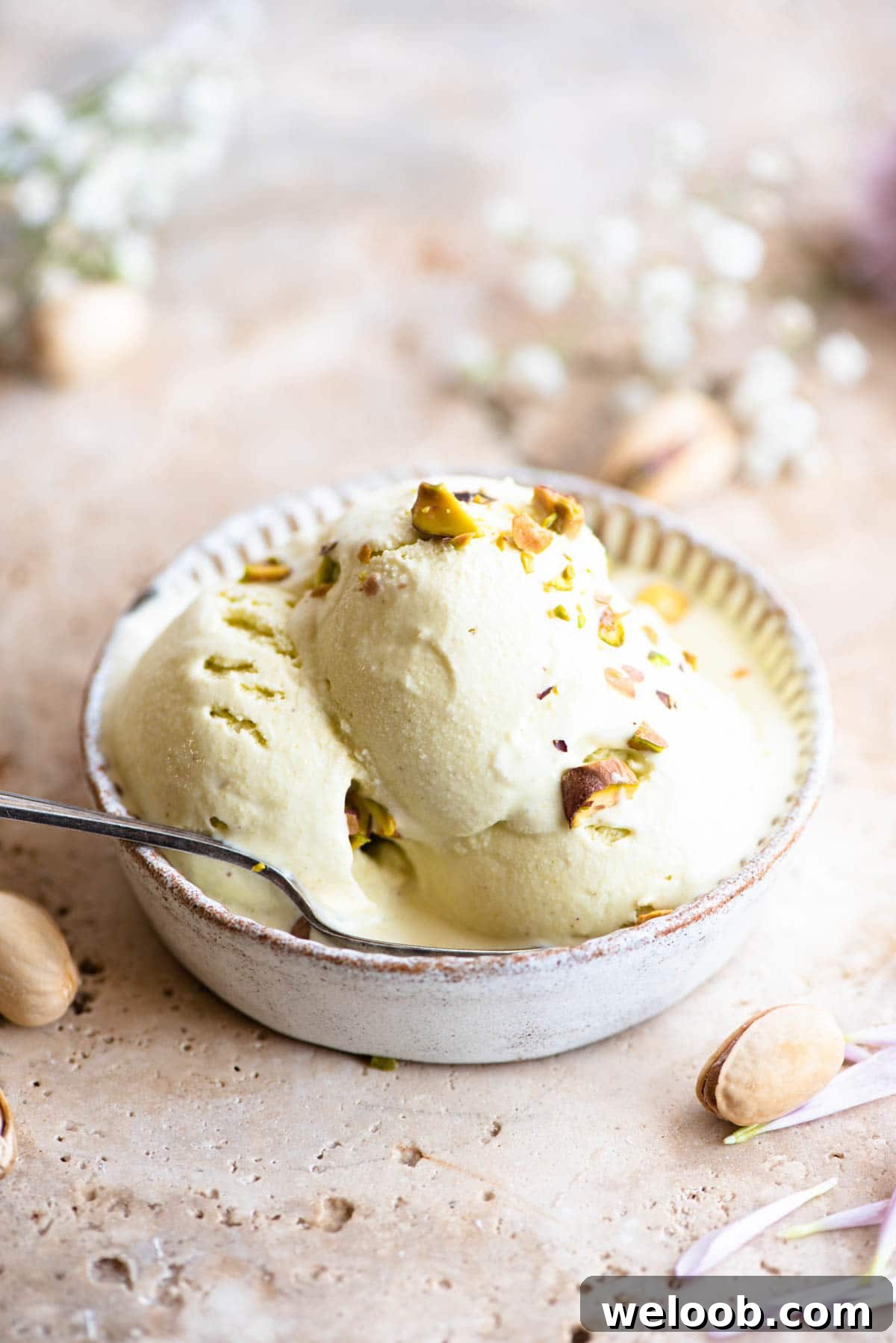 Three scoops of pistachio ice cream in a rustic looking ramekin