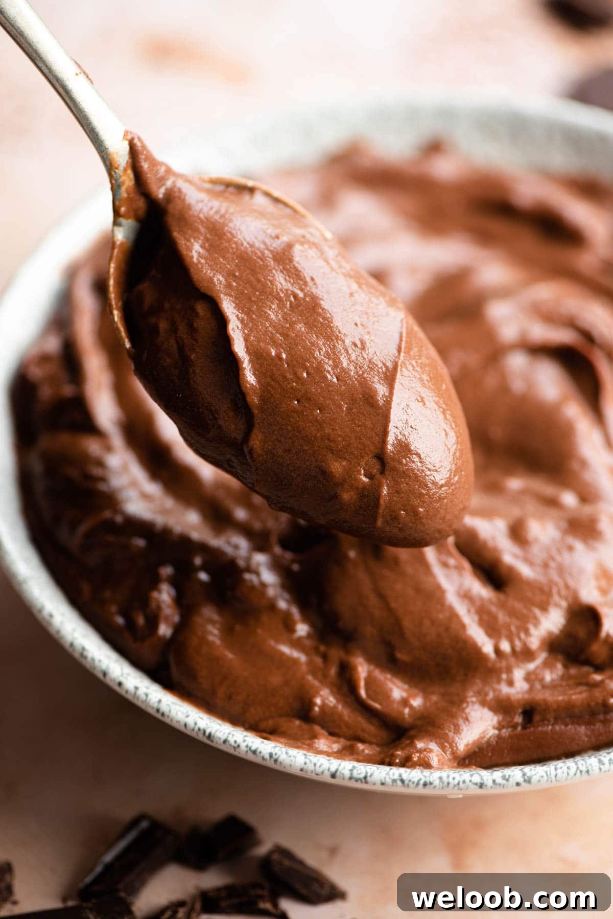 A close up of a spoonful of chocolate pastry cream
