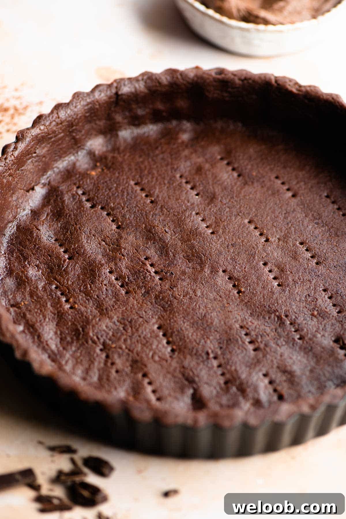 A close up of chocolate shortcrust pastry in a tart pan