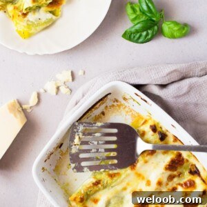 Homemade basil pesto is spread over fresh cannelloni pasta recipe and baked in a luscious cheesy provolone bechamel sauce and topped with mozzarella cheese, comfort food heaven! Insidetherustickitchen.com