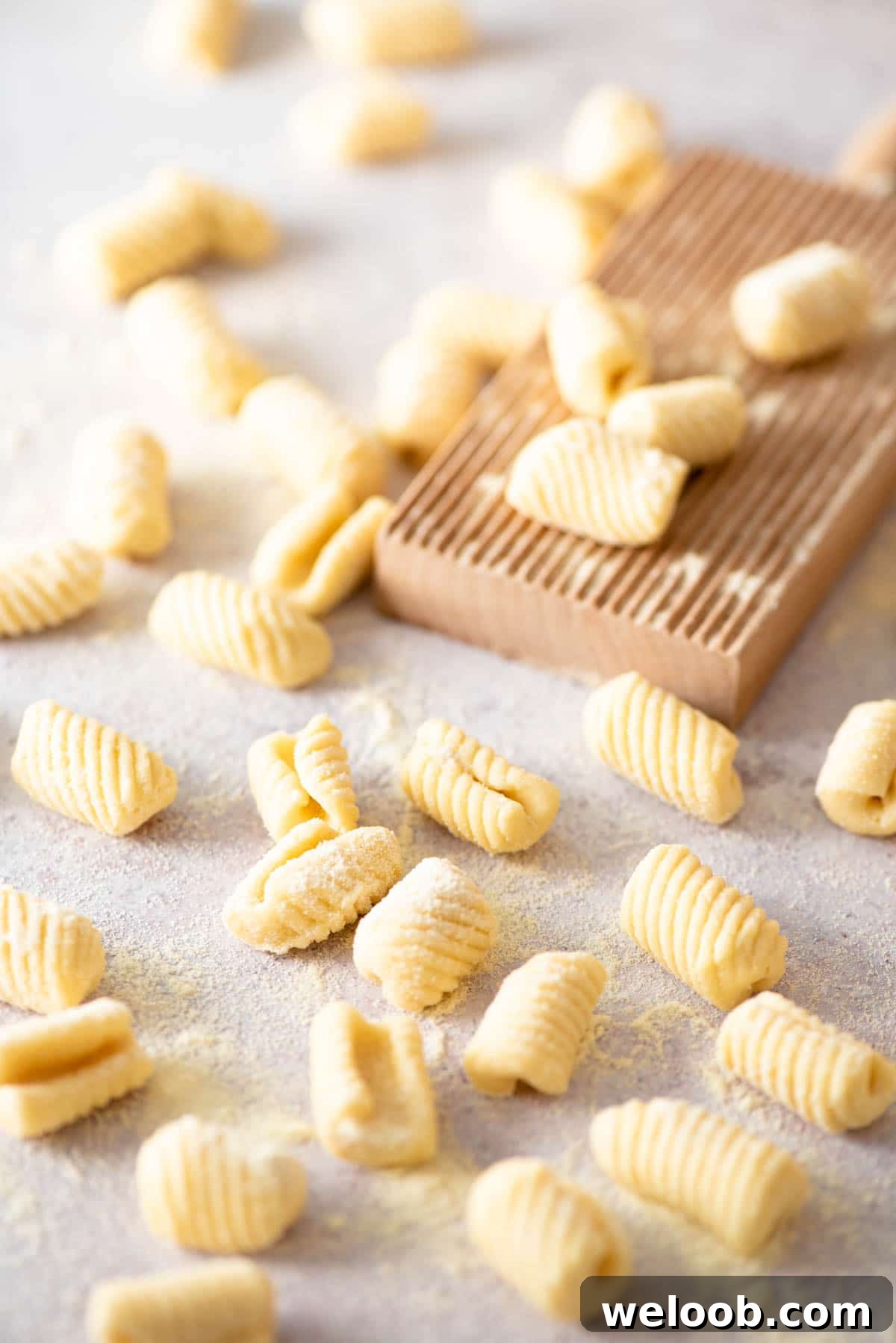 Gnochetti Sardi on a work surface with a gnocchi board