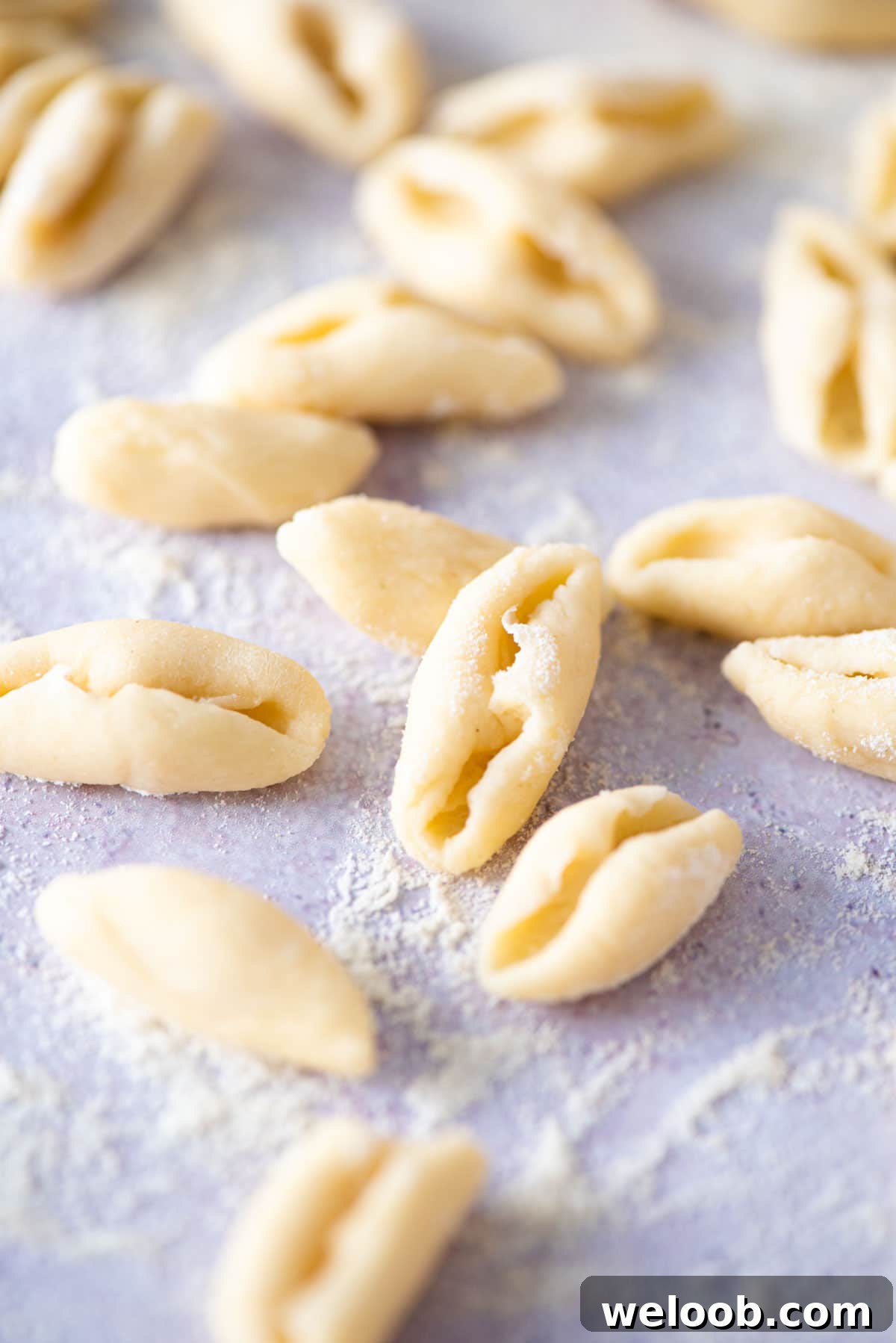 A close up of fresh cavatelli pasta on a blue work surface