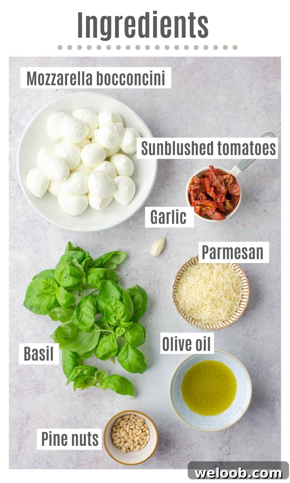 An overhead shot of all the ingredients you need to make mozzarella bocconcini, pesto and tomatoes