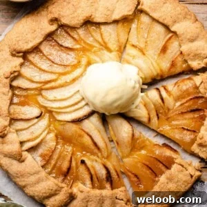 An overhead shot of an apple crostata with a scoop of ice cream in the middle