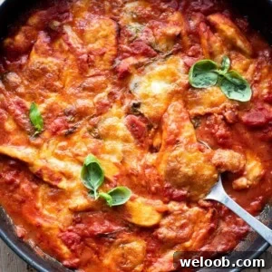 A close up of chicken sorrentina in a skillet