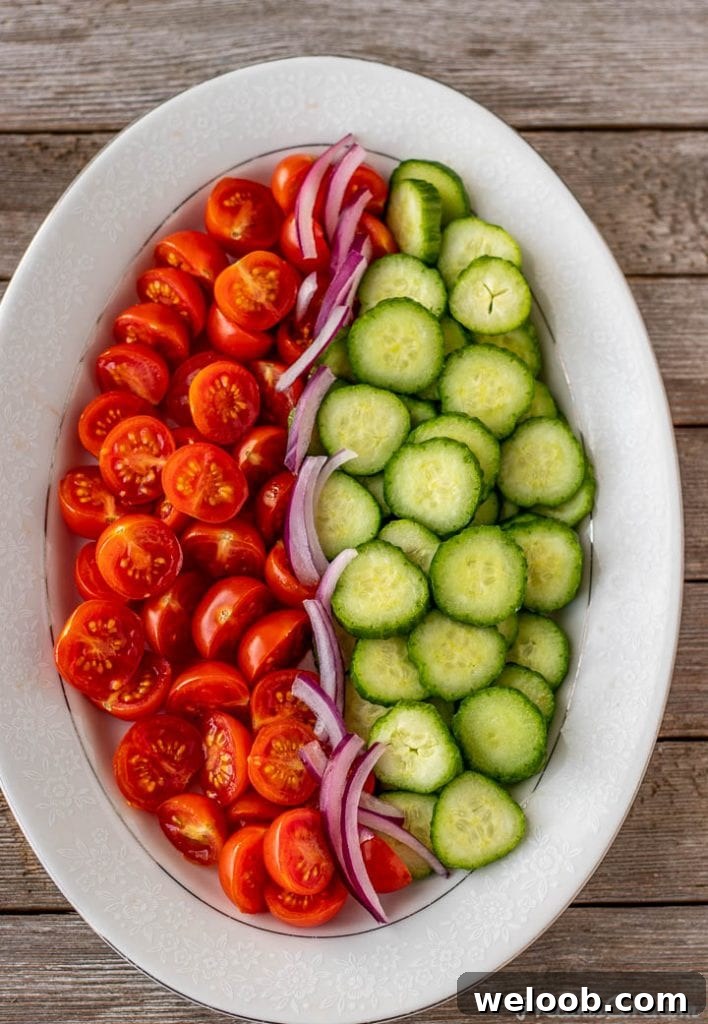 Chopped cucumber, tomatoes and onions on a platter