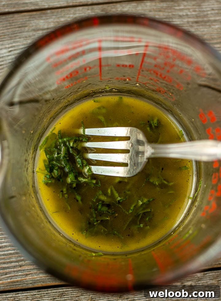 lemon basil salad dressing in a measuring cup
