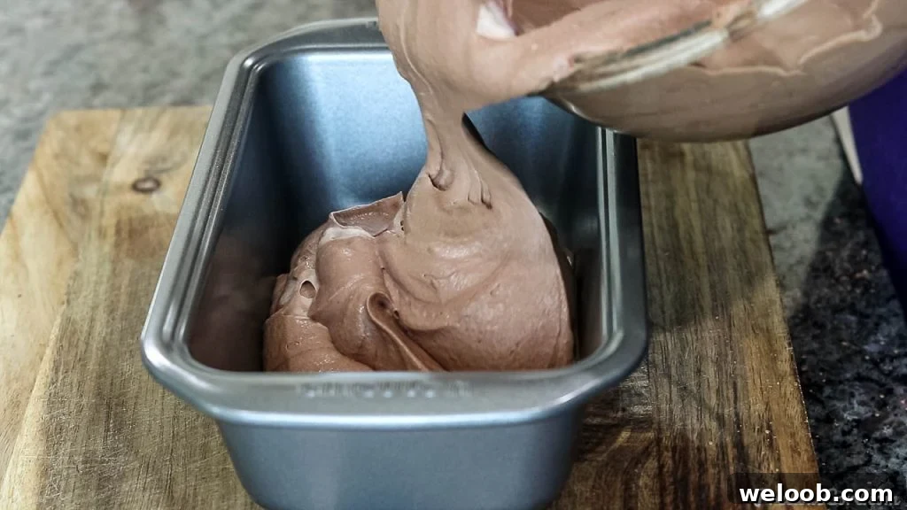 Pouring chocolate ice cream mixture into loaf pan