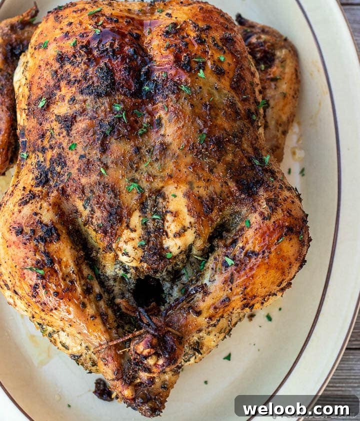 Whole herb roasted chicken on a platter