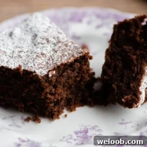 A slice of Torta Caprese cake on a plate cut in half