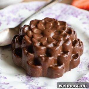 A chocolate budino on a small pink and white patterned plate