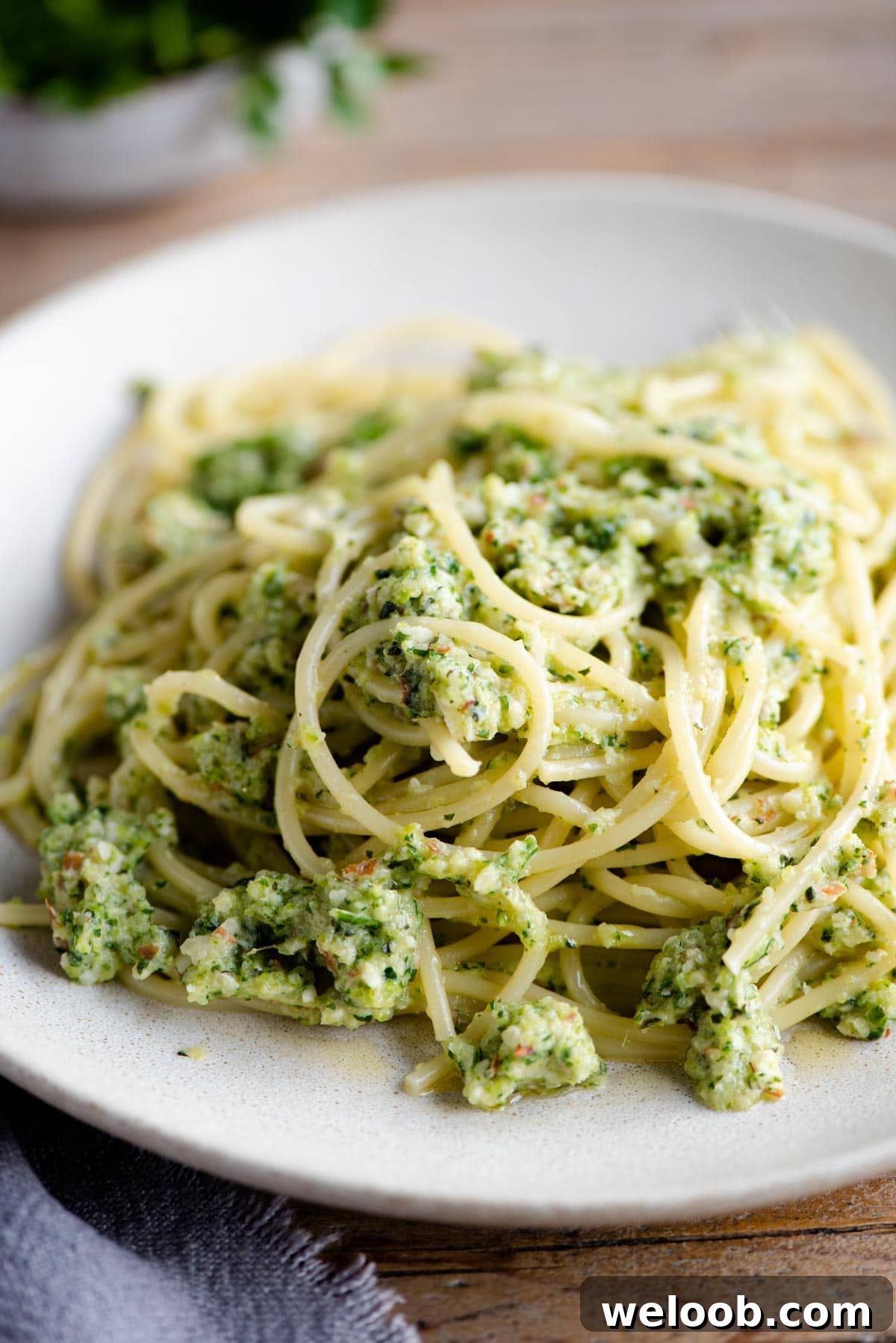 A close up of spaghetti with zucchini pesto on a plate