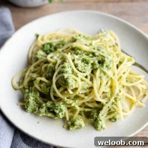 A close up of zucchini pesto pasta on a plate