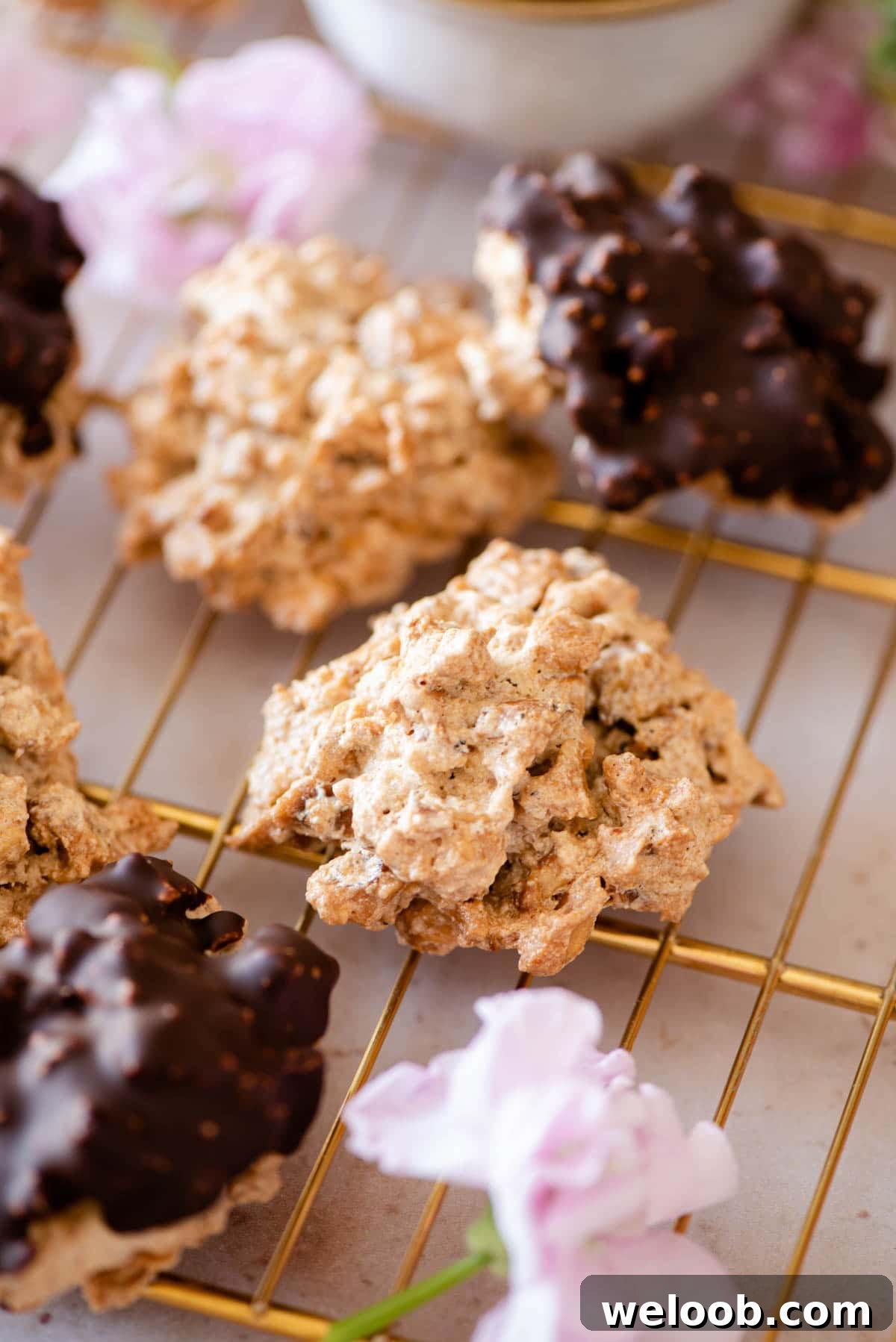 A close up of Brutti ma Buoni cookies on a gold cooling rack
