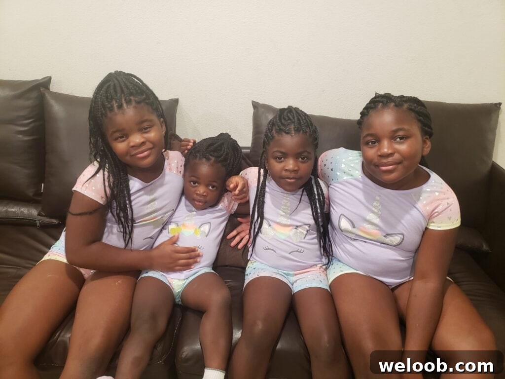 4 brown girls sitting on couch.