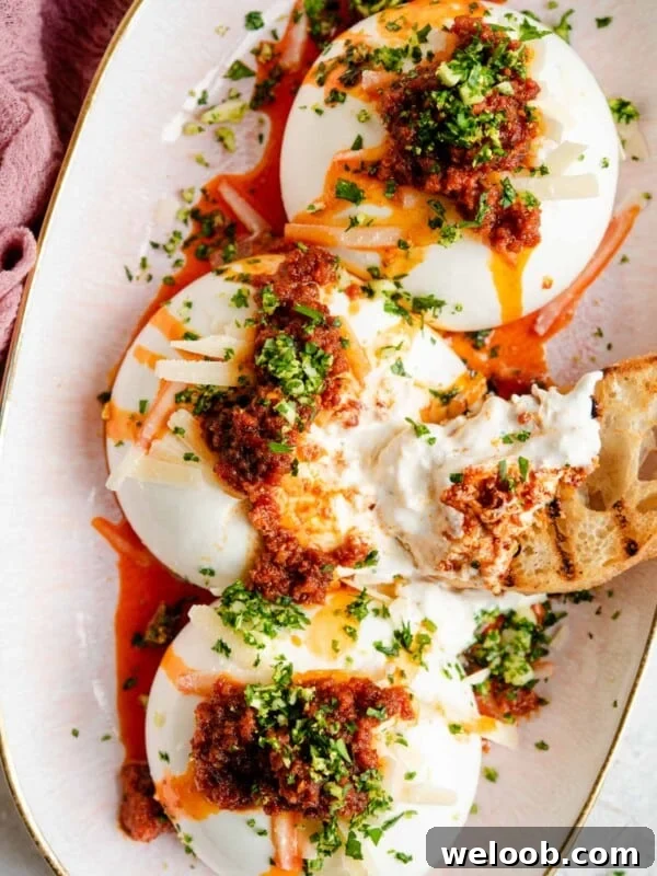 An overhead shot of burrata cheese on a serving plate with nduja and gremolata