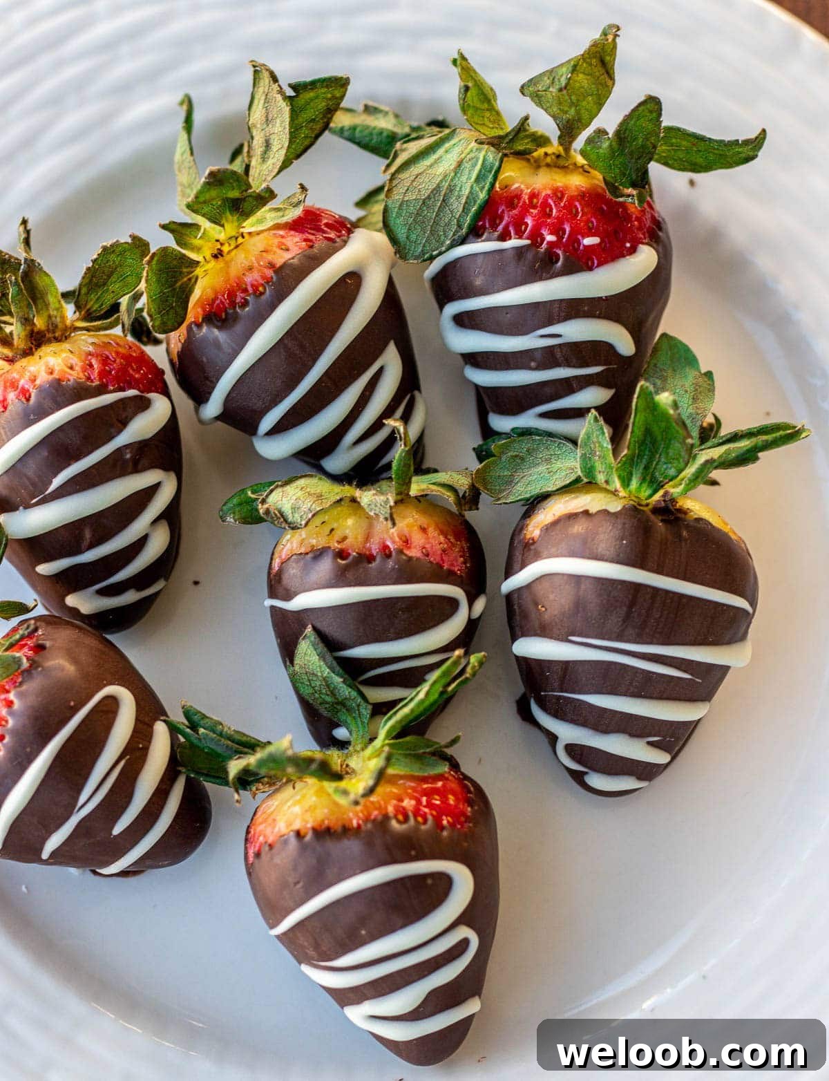 Chocolate dipped strawberries on a plate