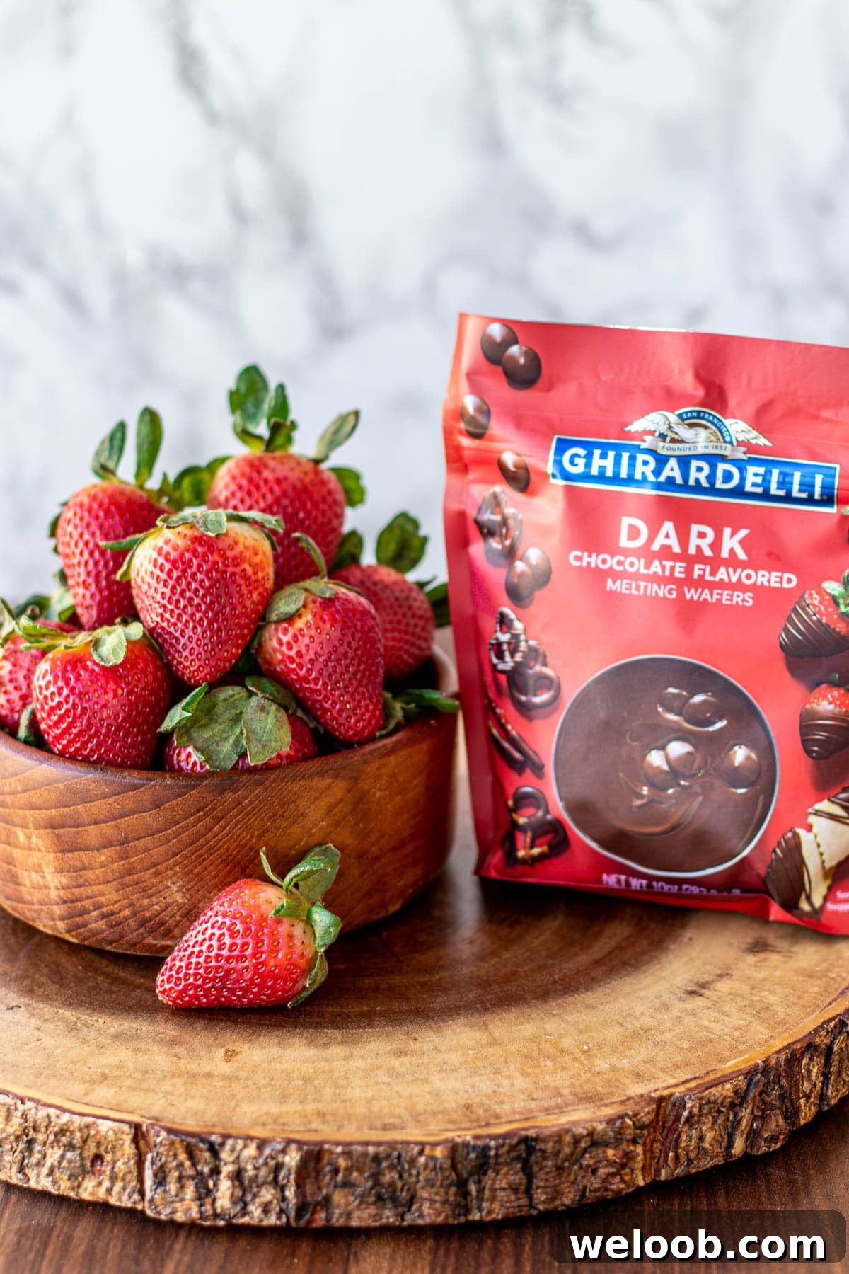 Strawberries in a bowl and melting chocolate in a bag