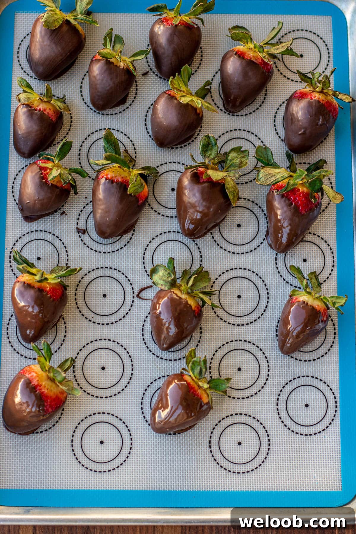 chocolate covered strawberries on a silicon mat