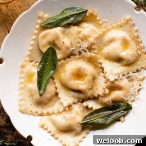 A cropped square image of butternut squash ravioli in a bowl with sage.