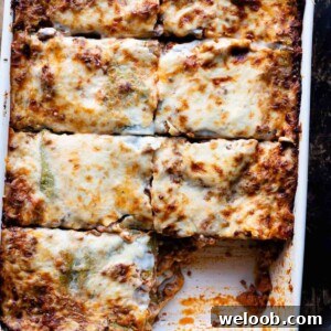 An overhead shot of lasagna cut into slices in a baking dish.