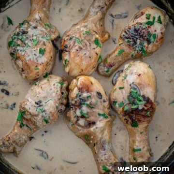 Chicken drumsticks in creamy sauce in a cast iron skillet