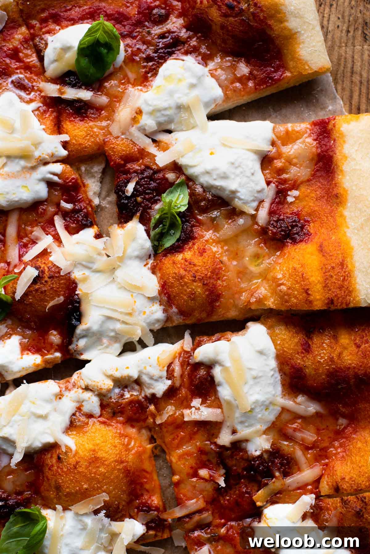 A close up of slices of pizza with Nduja and burrata cheese.